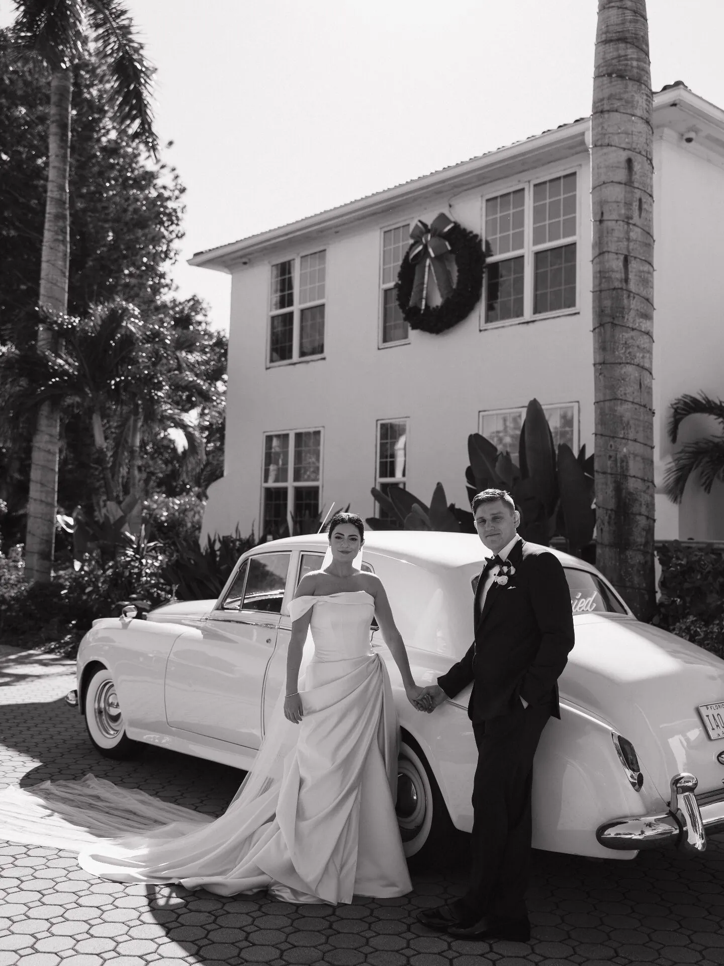 Bride and groom with vintage Rolls-Royce wedding car rental in Naples Florida